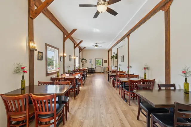 a view of a dining room with furniture window and wooden floor