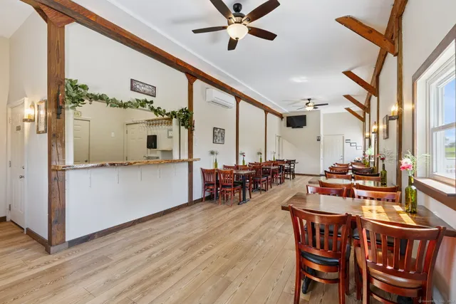 a view of a dining room with furniture window and wooden floor