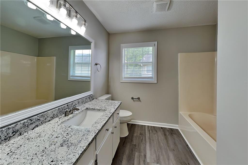 108 Ivy Trace Lane Dallas, GA 30157 - Photo 11 of 23 a bathroom with a granite countertop sink a toilet and window