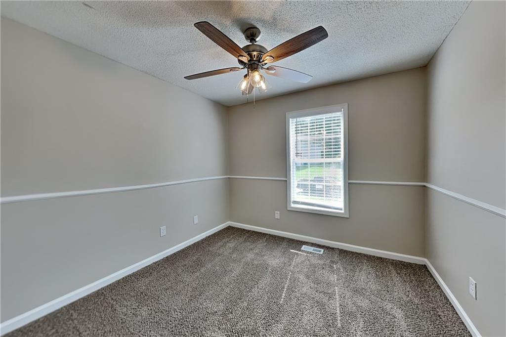 108 Ivy Trace Lane Dallas, GA 30157 - Photo 15 of 23 an empty room with a window and a ceiling fan