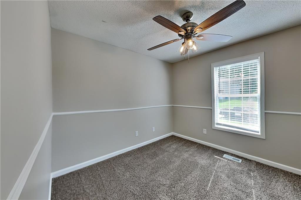 108 Ivy Trace Lane Dallas, GA 30157 - Photo 16 of 23 an empty room with a window and a ceiling fan