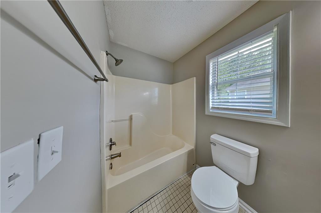 108 Ivy Trace Lane Dallas, GA 30157 - Photo 19 of 23 a white toilet sitting next to a bath tub shower