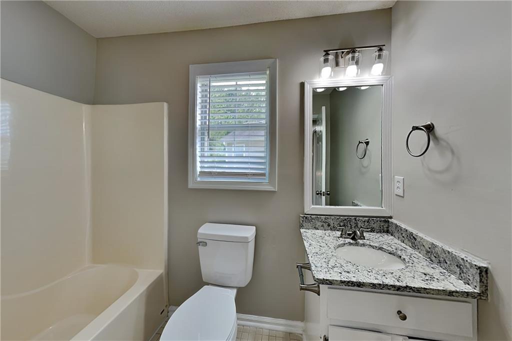 108 Ivy Trace Lane Dallas, GA 30157 - Photo 20 of 23 a bathroom with a granite countertop sink toilet and shower