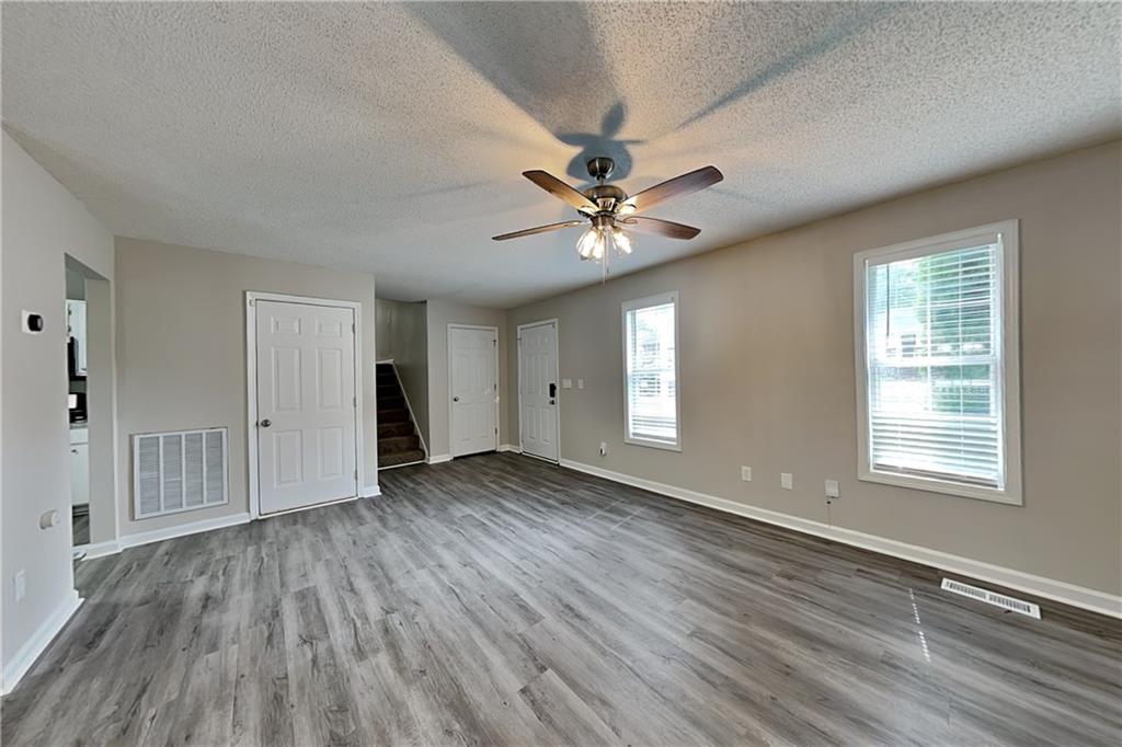 108 Ivy Trace Lane Dallas, GA 30157 - Photo 4 of 23 an empty room with wooden floor and windows
