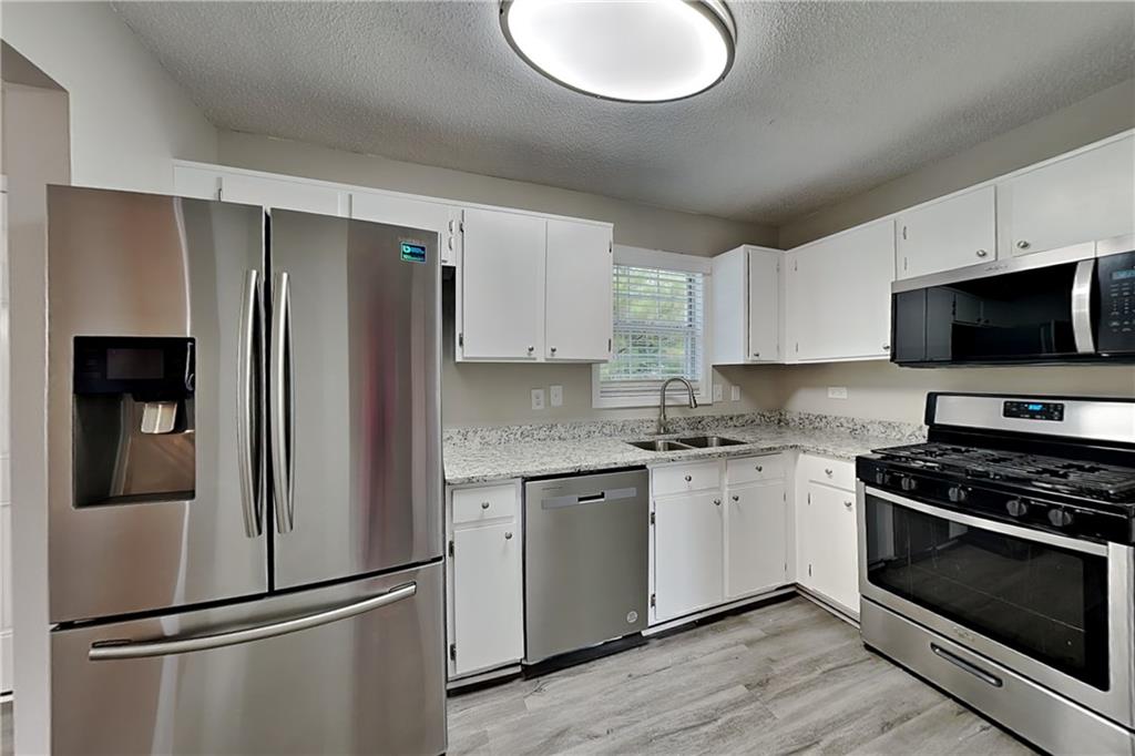 108 Ivy Trace Lane Dallas, GA 30157 - Photo 5 of 23 a kitchen with stainless steel appliances granite countertop a refrigerator stove and microwave