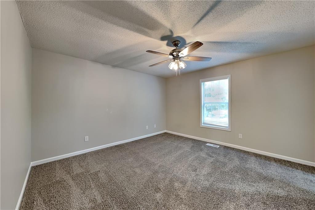 108 Ivy Trace Lane Dallas, GA 30157 - Photo 7 of 23 an empty room with a window and a fan