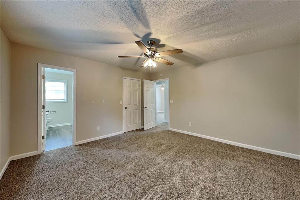 108 Ivy Trace Lane Dallas, GA 30157 - Photo 8 of 23 wooden floor in an empty room with a chandelier fan