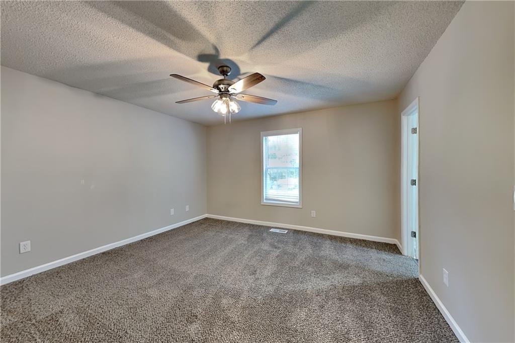 108 Ivy Trace Lane Dallas, GA 30157 - Photo 9 of 23 an empty room with a window and a fan