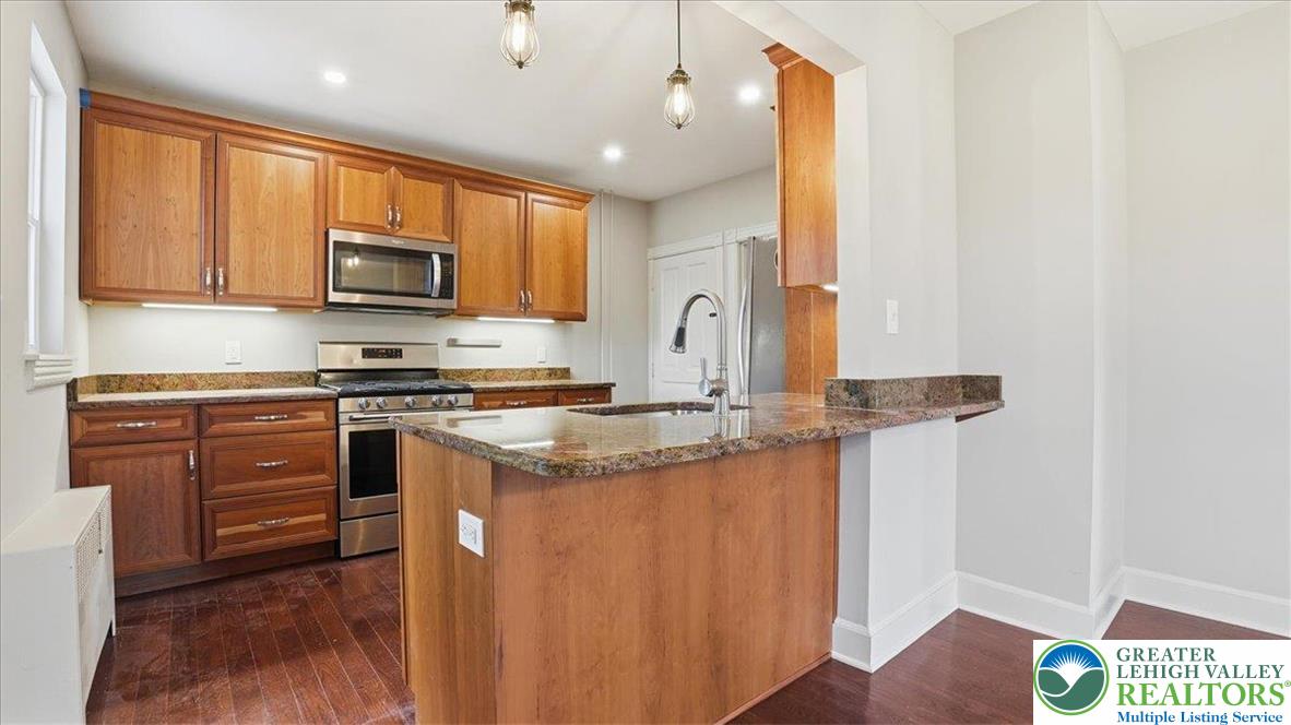 4441 Newburg Road Nazareth, PA 18064 - Photo 14 of 65 a kitchen with stainless steel appliances granite countertop a stove a sink and a microwave