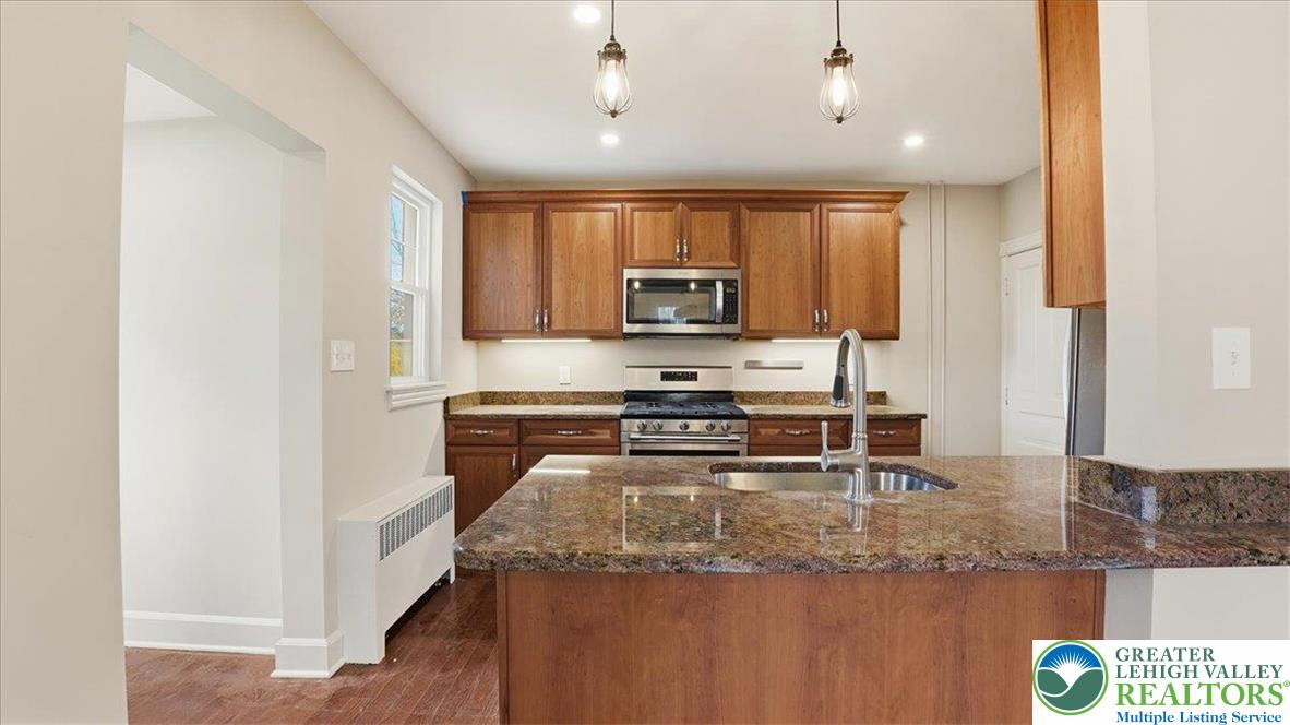 4441 Newburg Road Nazareth, PA 18064 - Photo 15 of 65 a kitchen with kitchen island a counter top space appliances and cabinets