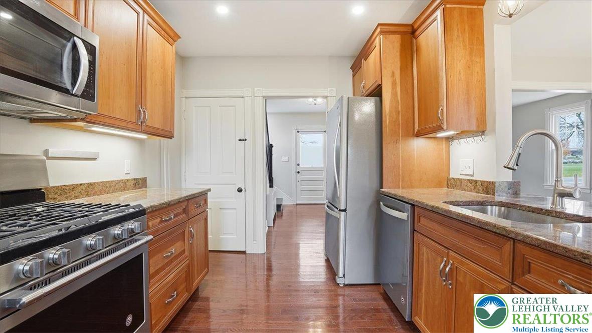 4441 Newburg Road Nazareth, PA 18064 - Photo 17 of 65 a kitchen with stainless steel appliances granite countertop a stove a sink and a refrigerator