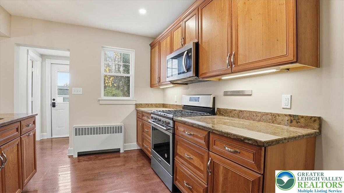 4441 Newburg Road Nazareth, PA 18064 - Photo 19 of 65 a kitchen with stainless steel appliances granite countertop a stove a sink and a microwave