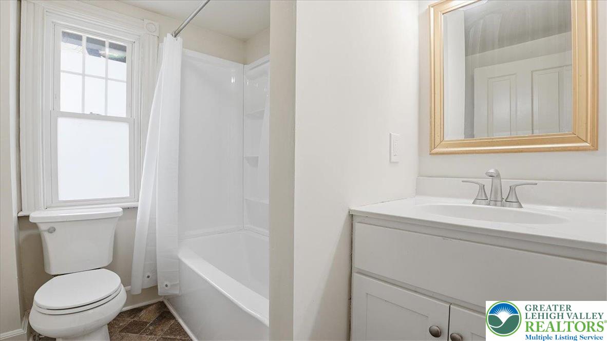 4441 Newburg Road Nazareth, PA 18064 - Photo 30 of 65 a bathroom with a granite countertop toilet a sink and a mirror