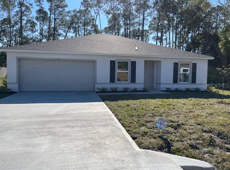 38 Smith Trail Palm Coast, FL 32164 - Photo 1 of 1 a front view of a house with garden