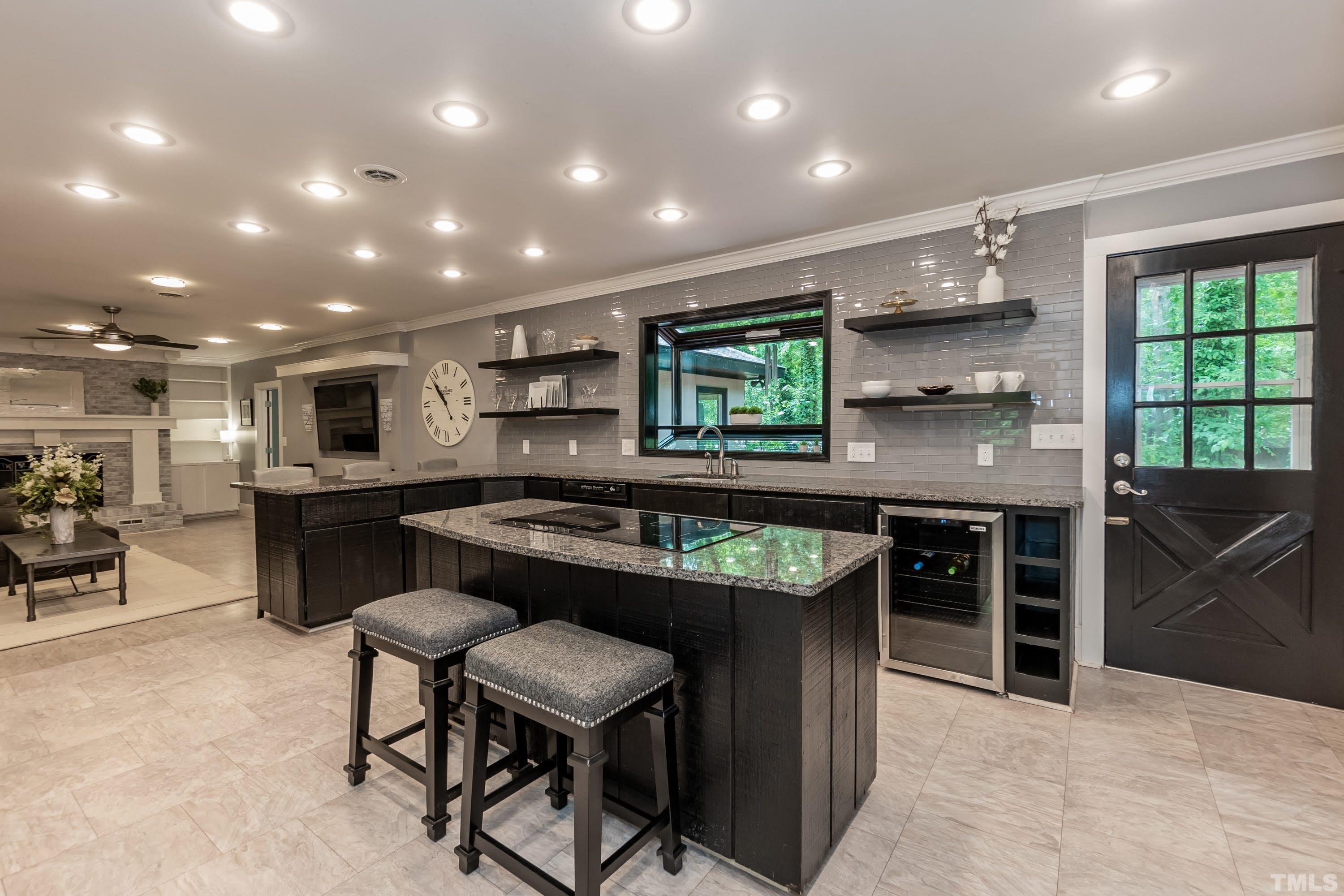 5601 Dutchman Drive Raleigh, NC 27606 - Photo 11 of 43 a kitchen with kitchen island stainless steel appliances a sink a stove a table and chairs