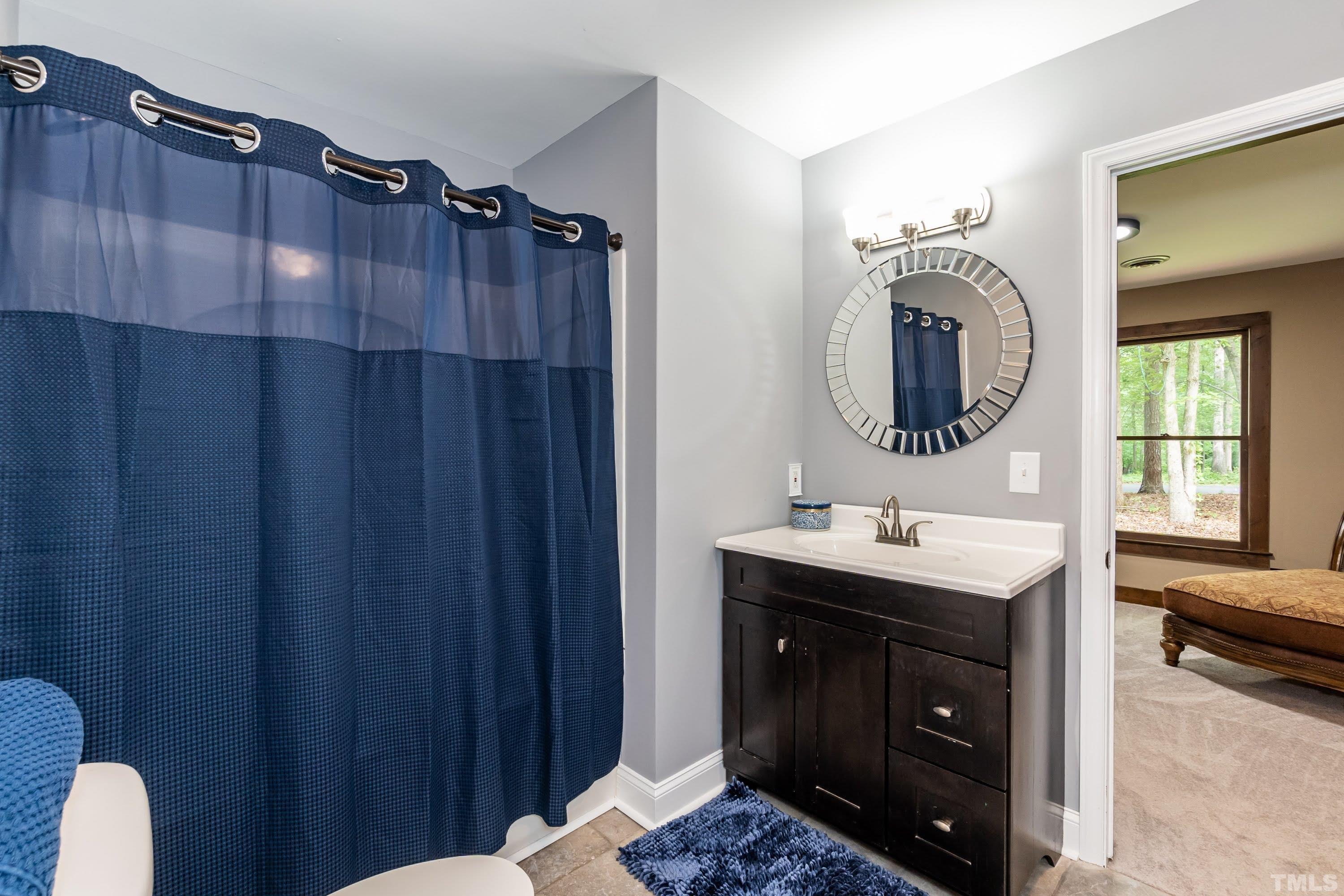5601 Dutchman Drive Raleigh, NC 27606 - Photo 14 of 43 a bathroom with a sink and a mirror