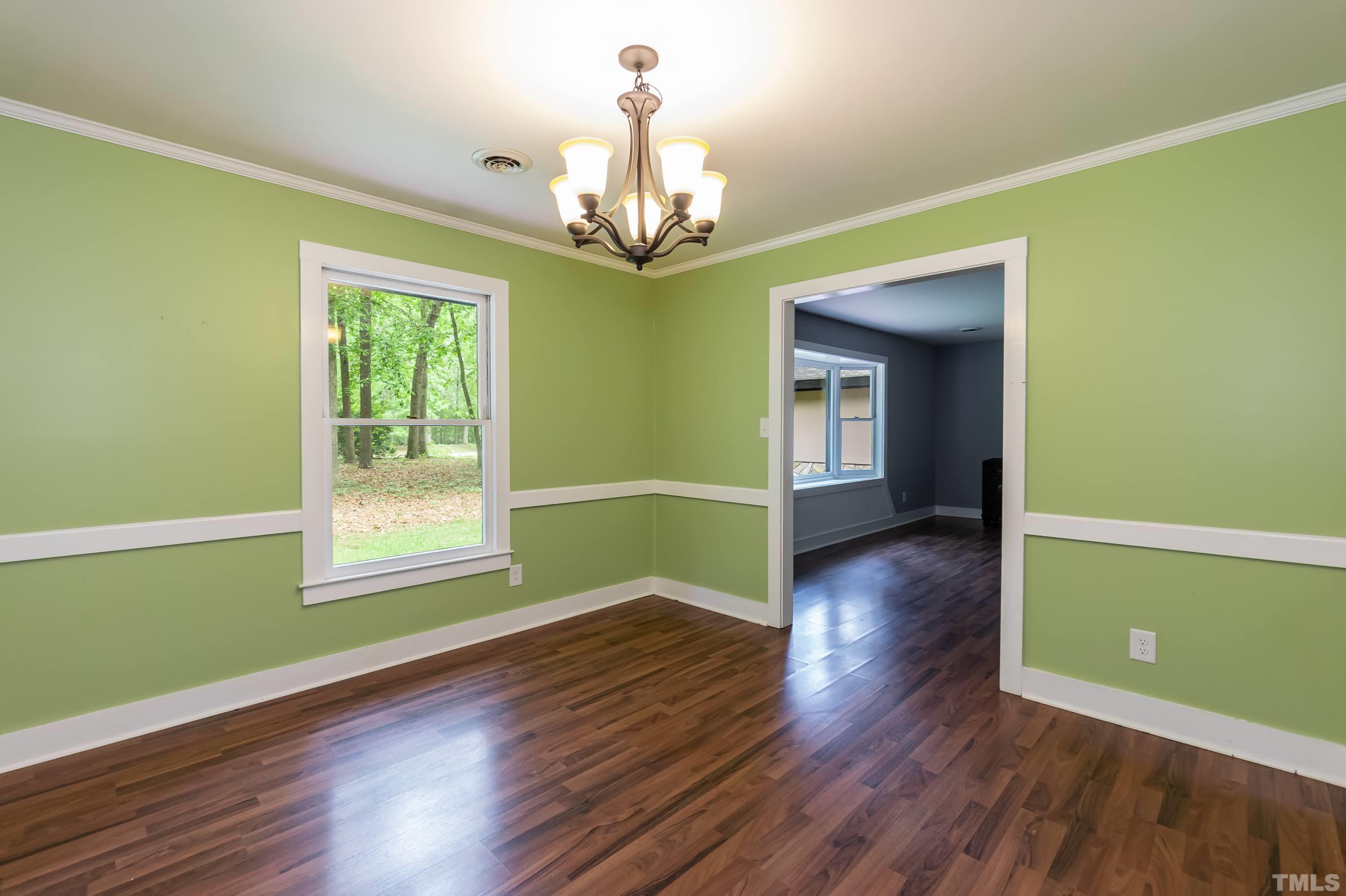 5601 Dutchman Drive Raleigh, NC 27606 - Photo 17 of 43 a view of an empty room with wooden floor and a window
