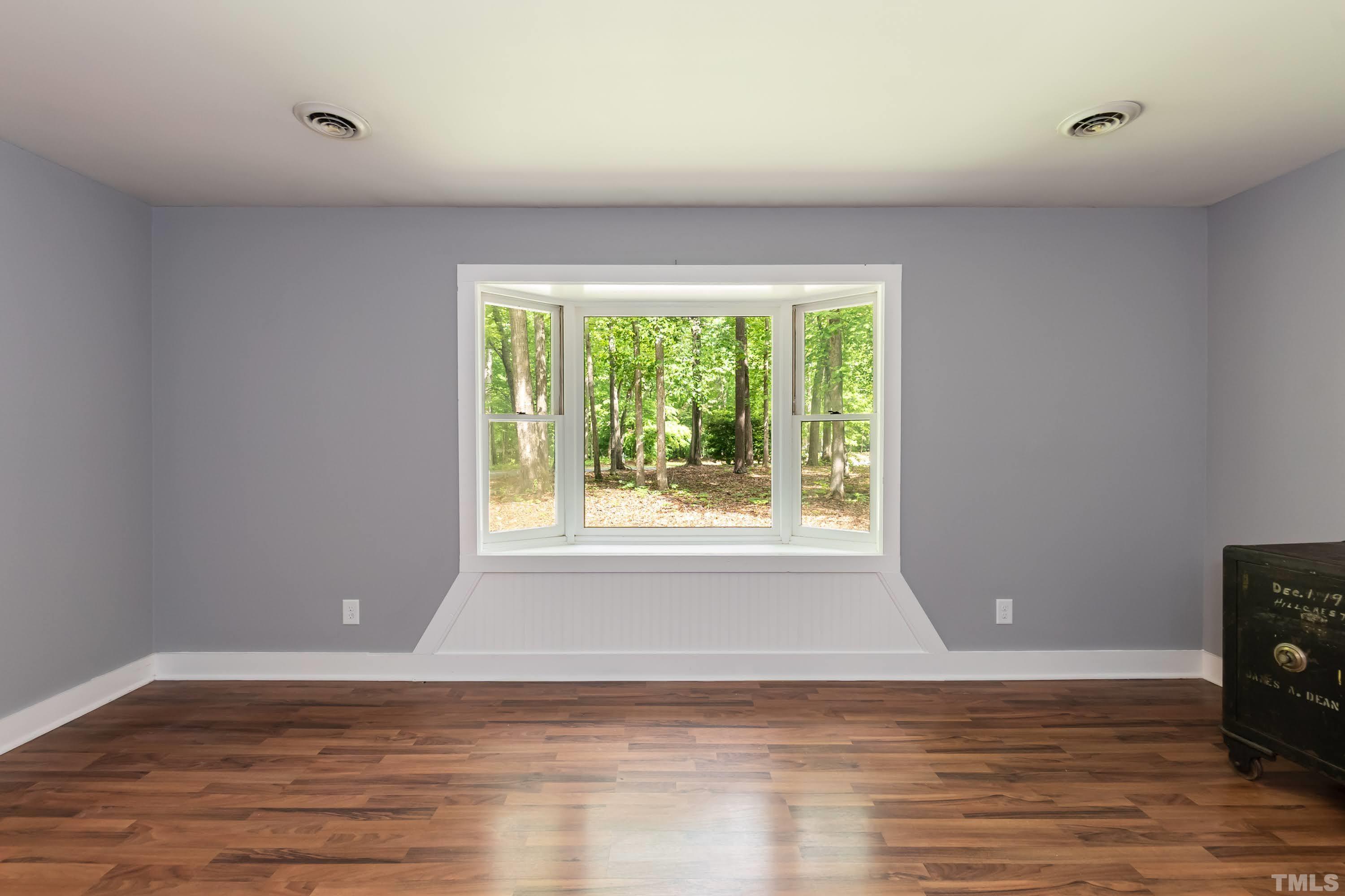 5601 Dutchman Drive Raleigh, NC 27606 - Photo 18 of 43 a view of a livingroom with wooden floor and a window