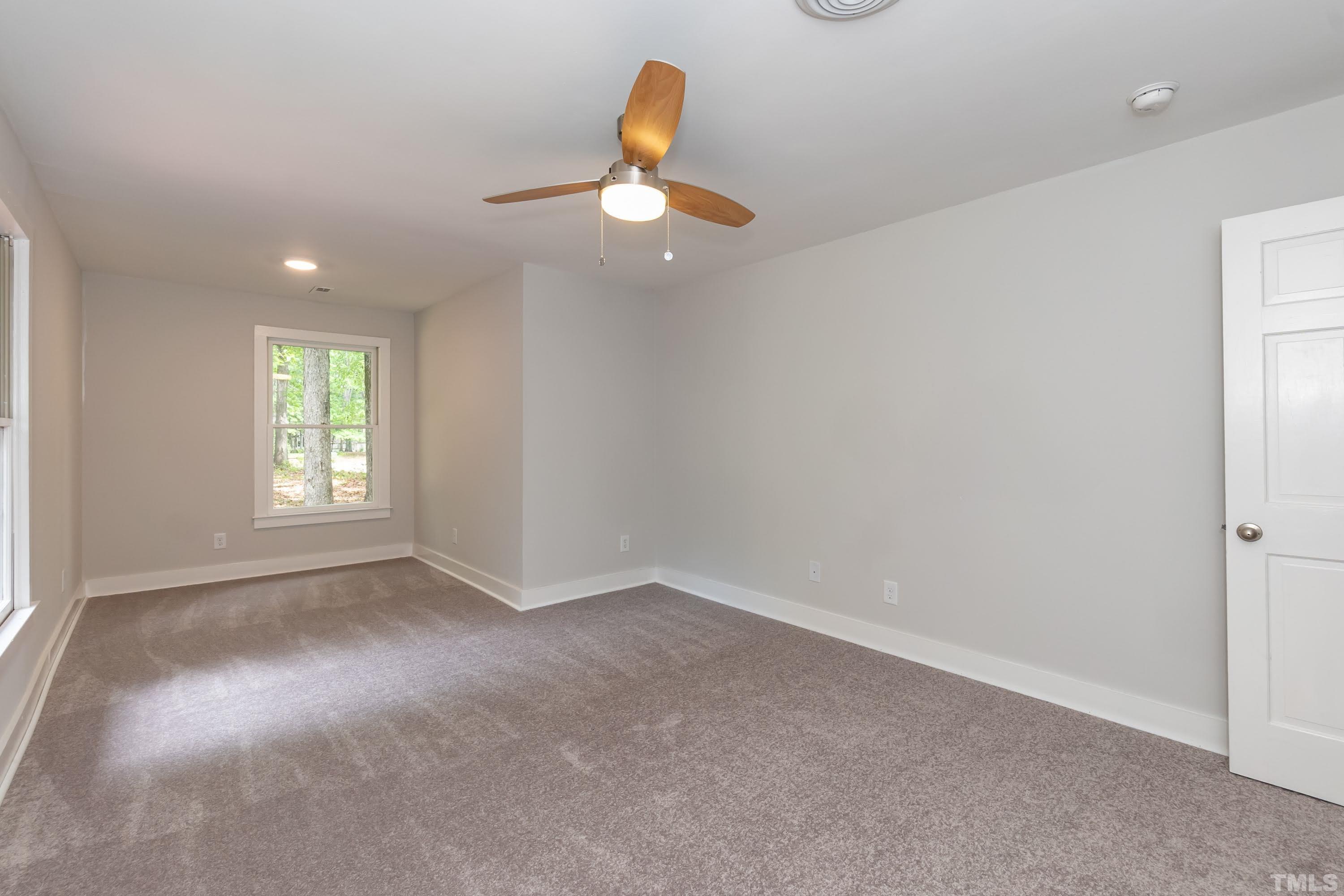 5601 Dutchman Drive Raleigh, NC 27606 - Photo 23 of 43 an empty room with windows and fan