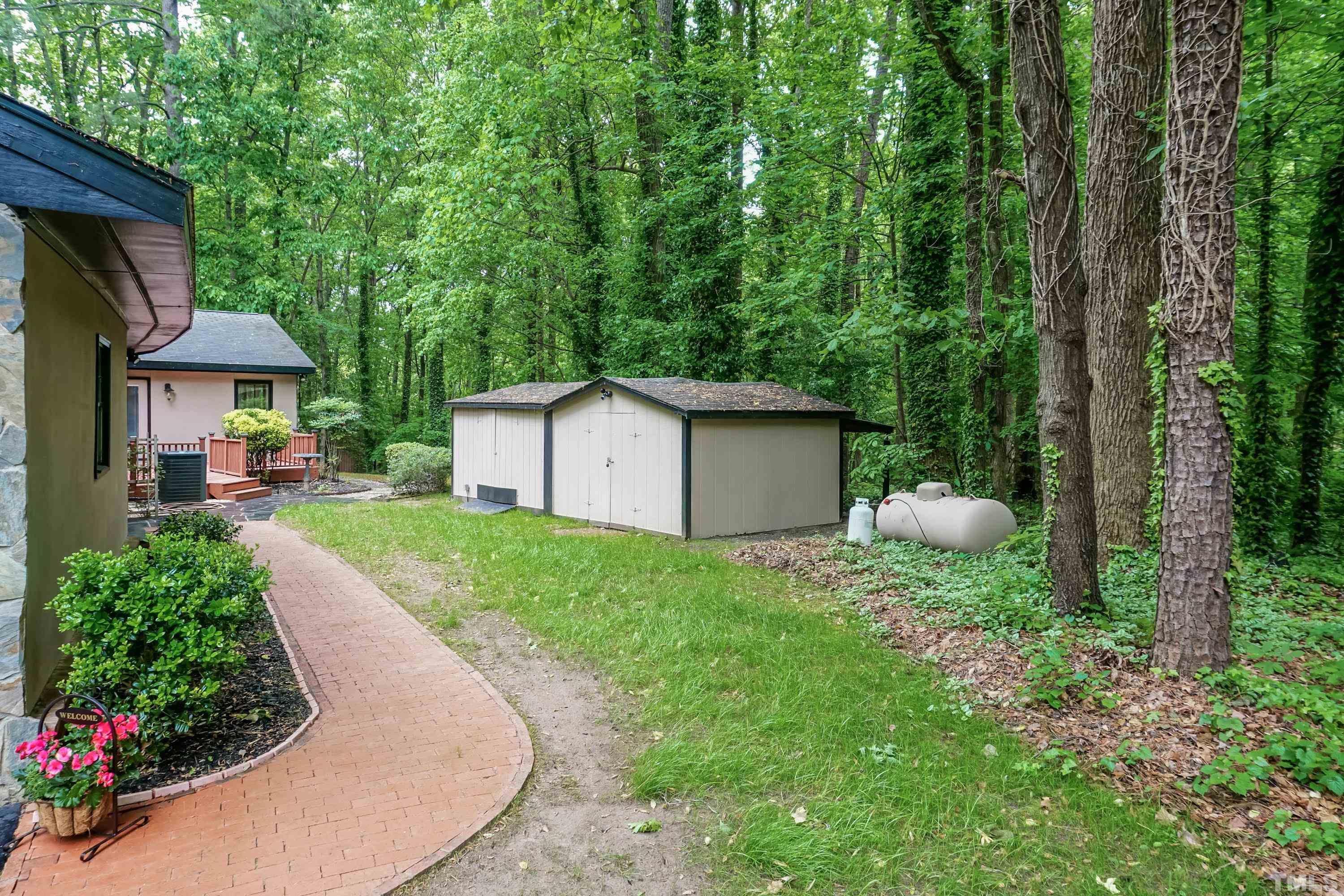 5601 Dutchman Drive Raleigh, NC 27606 - Photo 33 of 43 a view of a backyard with a garden and plants