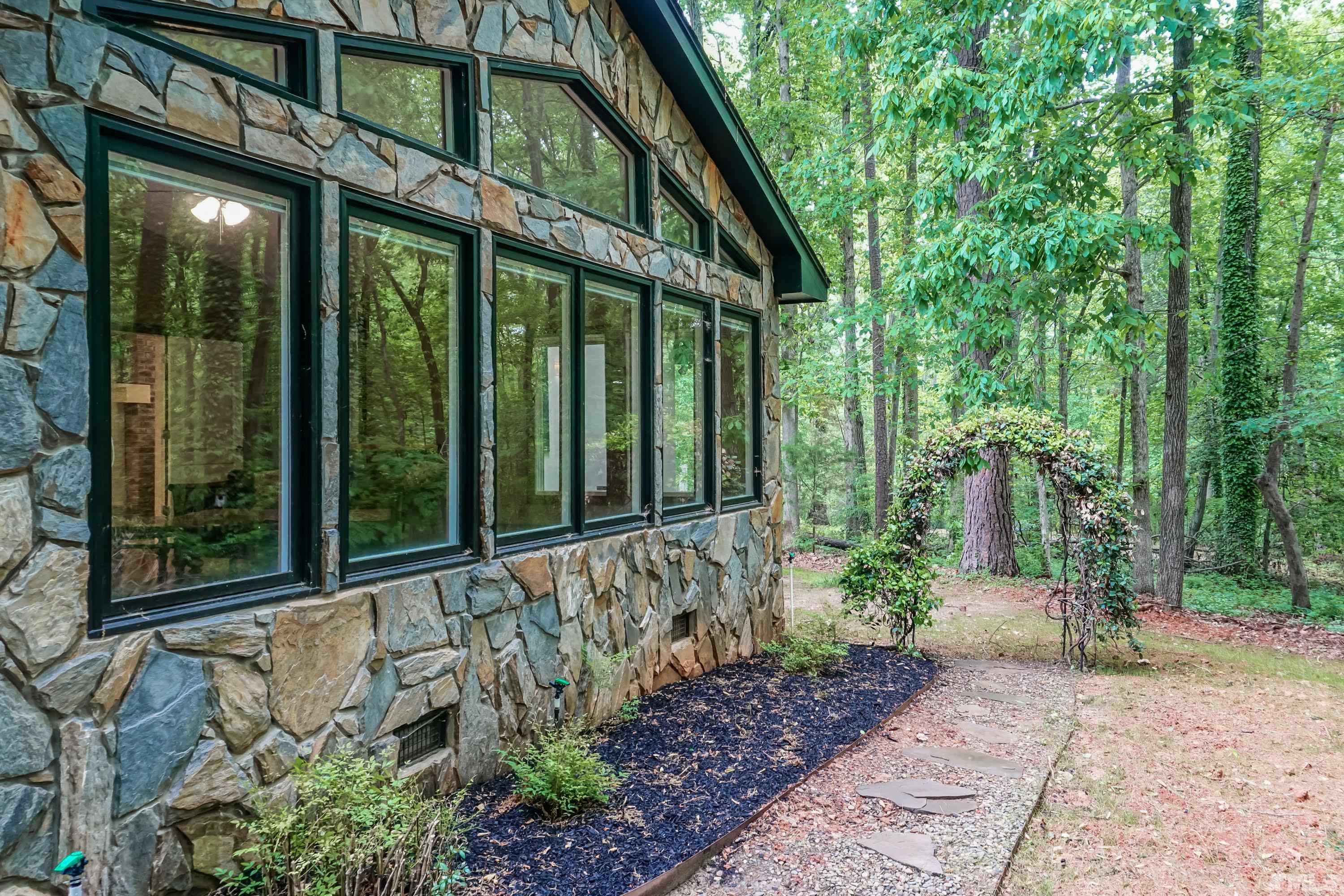 5601 Dutchman Drive Raleigh, NC 27606 - Photo 36 of 43 a view of a pathway of a house with plants