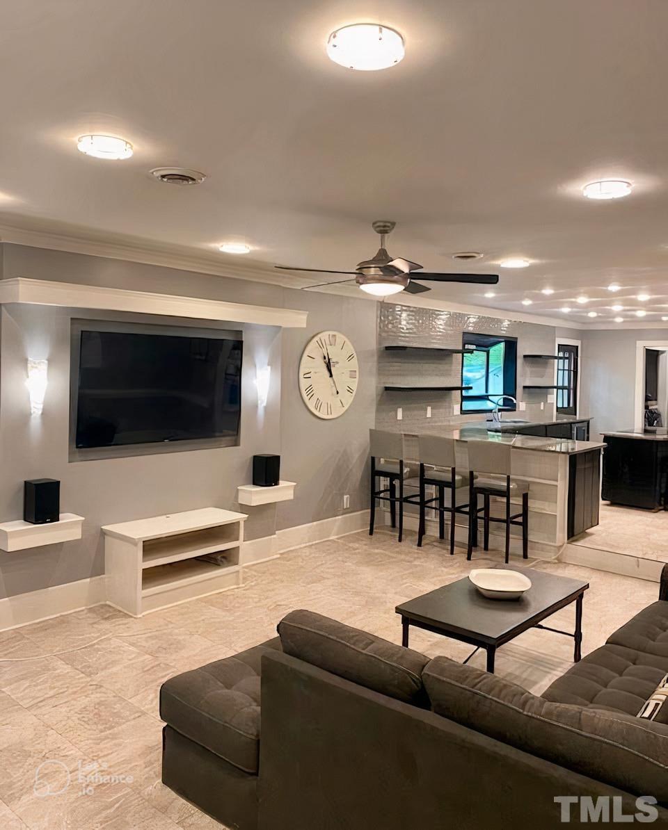 5601 Dutchman Drive Raleigh, NC 27606 - Photo 5 of 43 a living room with furniture and a flat screen tv