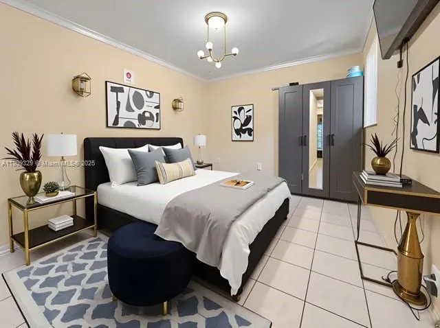 a bedroom with a bed and a chandelier