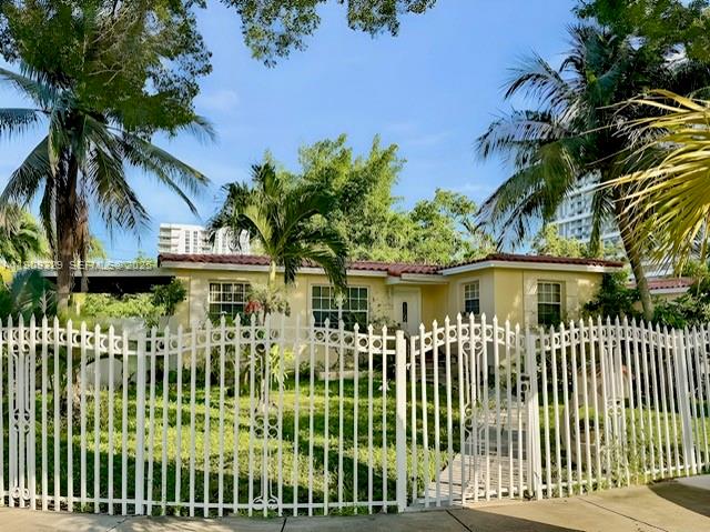2701 Southwest 29th Avenue Miami, FL 33133 - Photo 3 of 17 a front view of a house with a garden