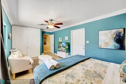 a bedroom with a large bed couch and a window