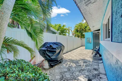 a view of backyard with outdoor seating and plants