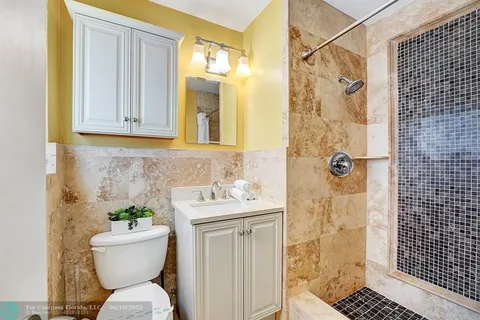 a bathroom with a sink toilet and shower
