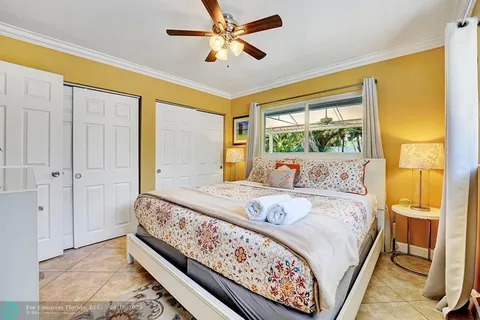 a bed sitting in a bedroom next to a window