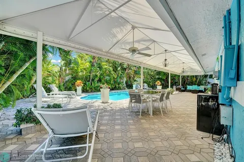a view of a patio with a table chairs and a backyard
