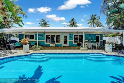 a view of a house with swimming pool yard and patio