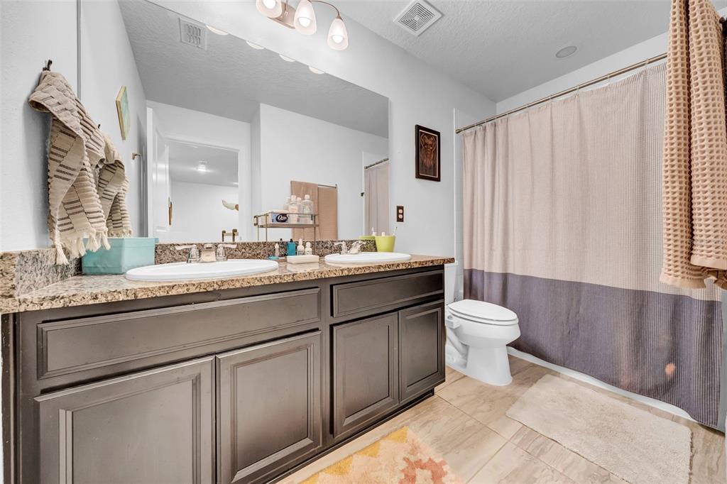 4007 Palm Key Avenue Oldsmar, FL 34677 - Photo 14 of 30 a bathroom with a sink a toilet and a mirror