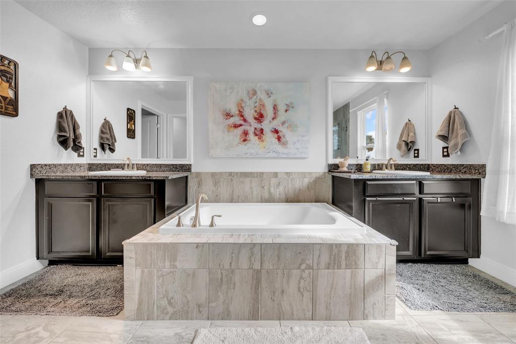 4007 Palm Key Avenue Oldsmar, FL 34677 - Photo 19 of 30 a spacious bedroom with a bed and a chandelier