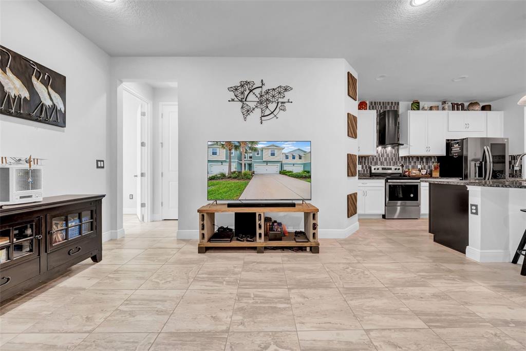 4007 Palm Key Avenue Oldsmar, FL 34677 - Photo 4 of 30 a living room with stainless steel appliances furniture a fireplace and a kitchen view