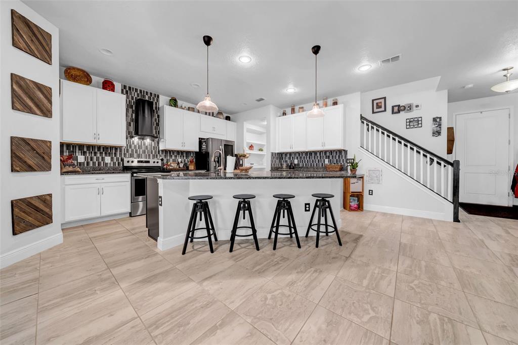 4007 Palm Key Avenue Oldsmar, FL 34677 - Photo 6 of 30 a large white kitchen with lots of counter space and windows
