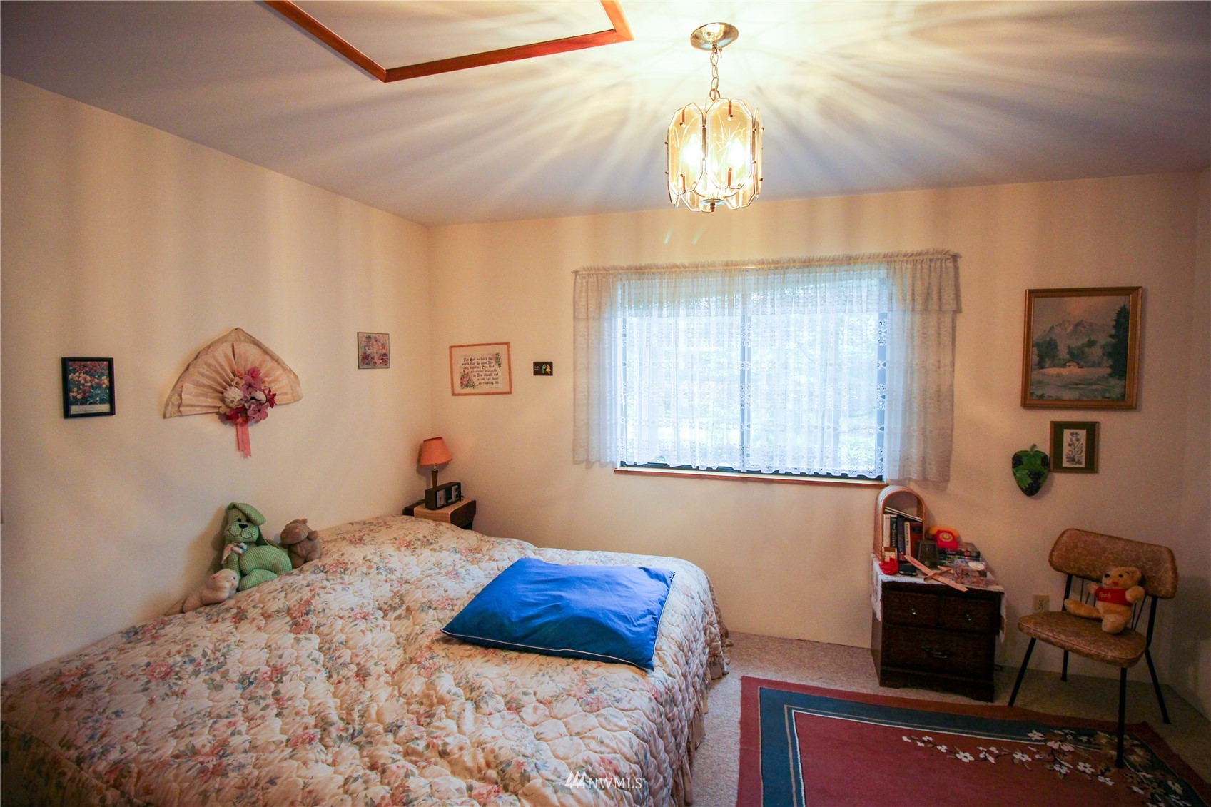 8014 Valley View Road Custer, WA 98240 - Photo 16 of 28 a bedroom with a bed and a chandelier