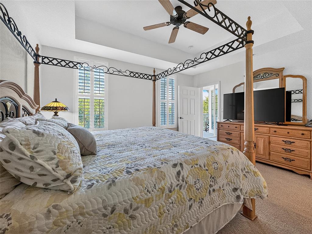 920 Spring Park Street, Unit 303 Celebration, FL 34747 - Photo 17 of 40 a bedroom with a bed window and a flat screen tv