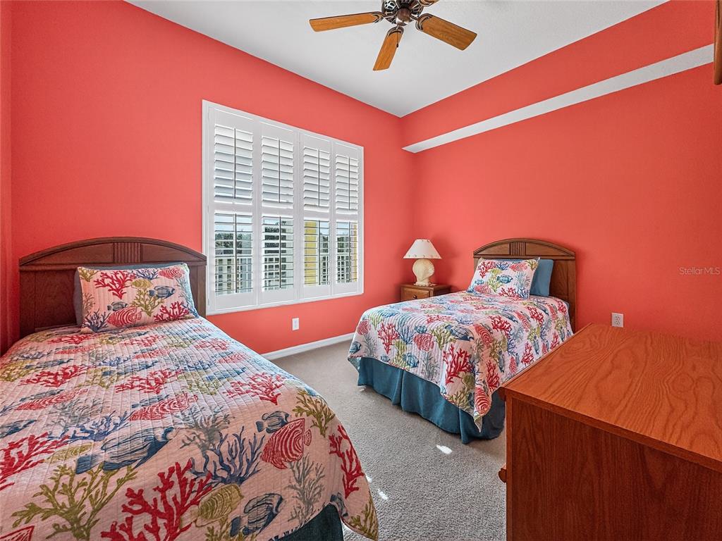 920 Spring Park Street, Unit 303 Celebration, FL 34747 - Photo 22 of 40 a bedroom with a large bed and a chandelier