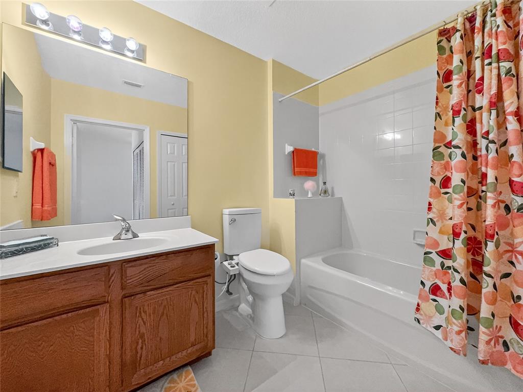 920 Spring Park Street, Unit 303 Celebration, FL 34747 - Photo 24 of 40 a bathroom with a sink toilet and shower