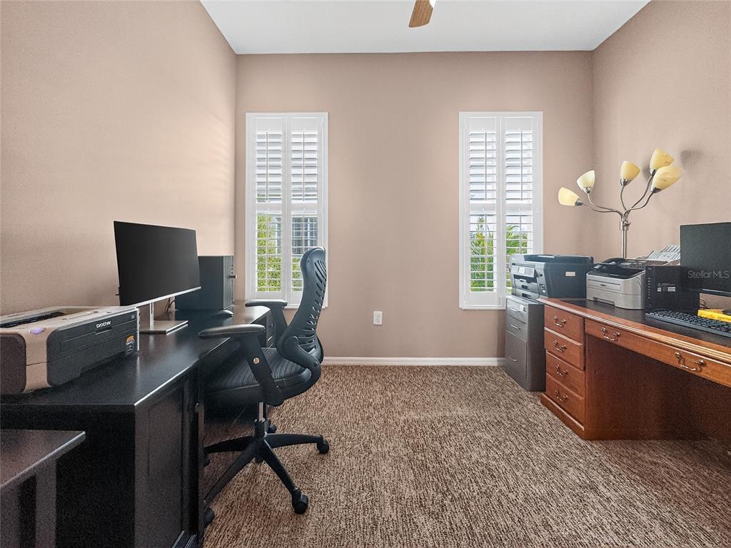 920 Spring Park Street, Unit 303 Celebration, FL 34747 - Photo 27 of 40 a view of a workspace with furniture and a window