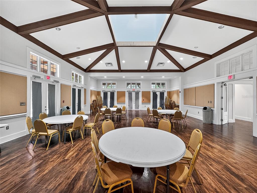 920 Spring Park Street, Unit 303 Celebration, FL 34747 - Photo 35 of 40 a view of a dining room with furniture wooden floor and chandelier