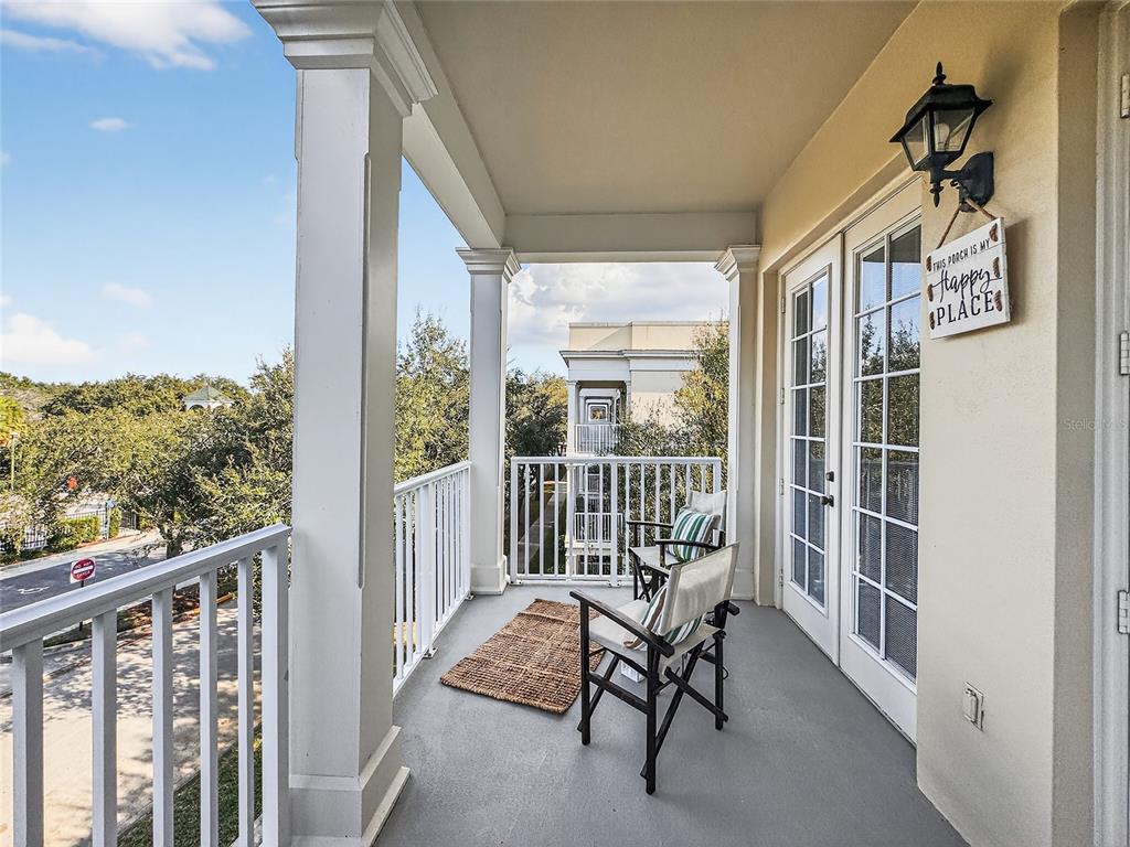 920 Spring Park Street, Unit 303 Celebration, FL 34747 - Photo 5 of 40 a view of a balcony with chair and wooden floor