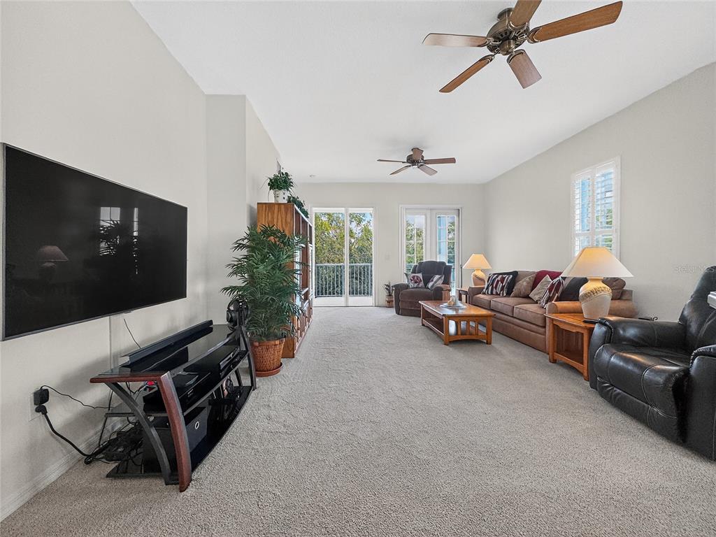 920 Spring Park Street, Unit 303 Celebration, FL 34747 - Photo 9 of 40 a living room with furniture and a flat screen tv
