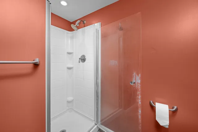 a bathroom with a shower and a sink