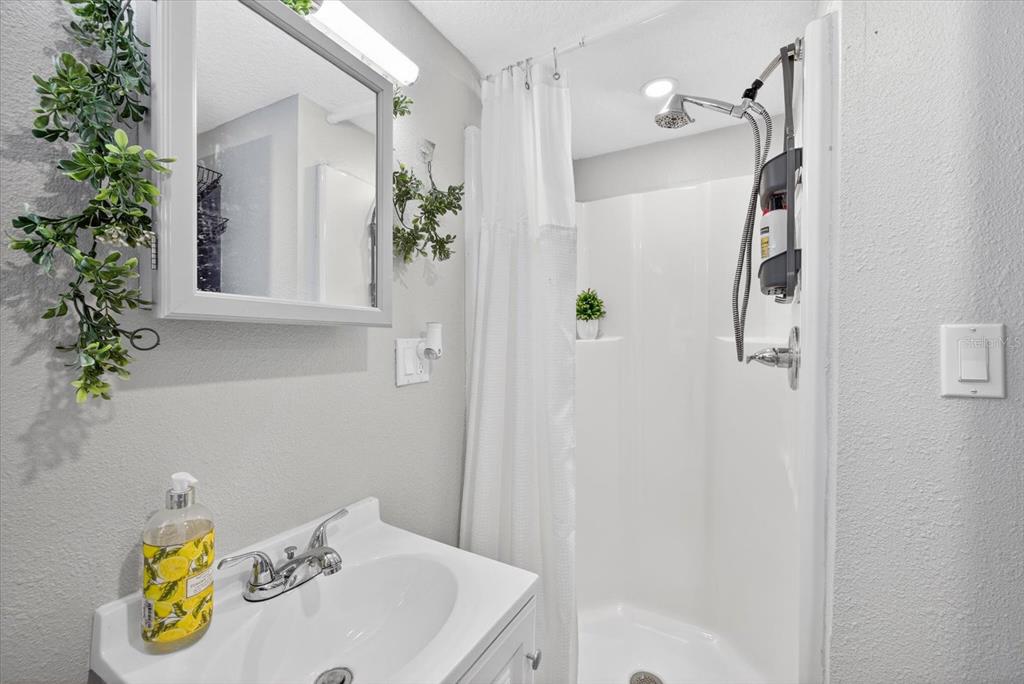 7286 Aberdeen Court Weeki Wachee, FL 34607 - Photo 15 of 37 a bathroom with a tub and shower