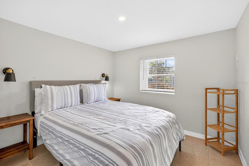 7286 Aberdeen Court Weeki Wachee, FL 34607 - Photo 16 of 37 a large bed sitting in a bedroom next to a window