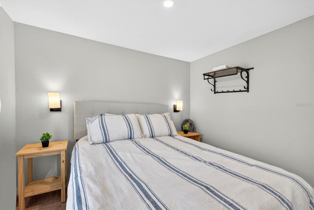 7286 Aberdeen Court Weeki Wachee, FL 34607 - Photo 17 of 37 a bed room with a bed and a painting